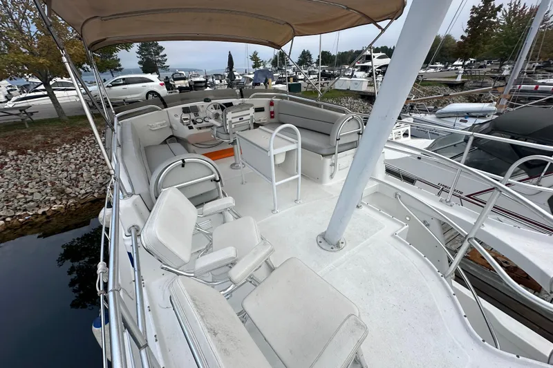 Lucky Dog Yacht Photos Pics 2002 Mainship 390 Trawler boat interior with seating and helm, docked at marina.