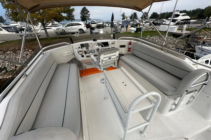 Lucky Dog Yacht Photos Pics 2002 Mainship 390 Trawler helm with seating, docked at marina.