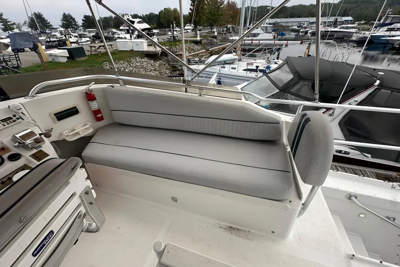Lucky Dog Yacht Photos Pics 2002 Mainship 390 Trawler with gray seating, docked at a marina.