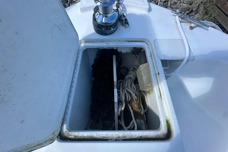 Lucky Dog Yacht Photos Pics Open hatch on 2002 Mainship 390 Trawler showing ropes and equipment storage.