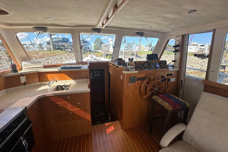 Lucky Dog Yacht Photos Pics 2002 Mainship 390 Trawler interior with helm, kitchen, and seating area.