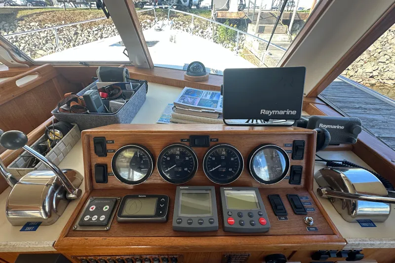 Lucky Dog Yacht Photos Pics 2002 Mainship 390 Trawler helm with Raymarine navigation equipment and control panel.