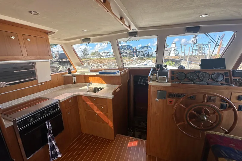 Lucky Dog Yacht Photos Pics Interior of 2002 Mainship 390 Trawler with wooden cabinetry and helm station.