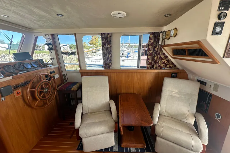 Lucky Dog Yacht Photos Pics 2002 Mainship 390 Trawler interior with helm, seating, and wooden accents.