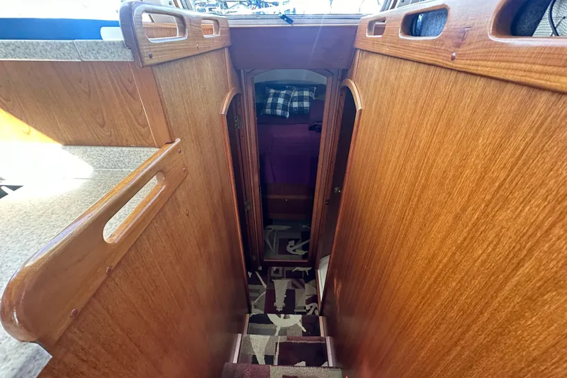 Lucky Dog Yacht Photos Pics 2002 Mainship 390 Trawler interior with wooden stairs and cozy cabin entrance.