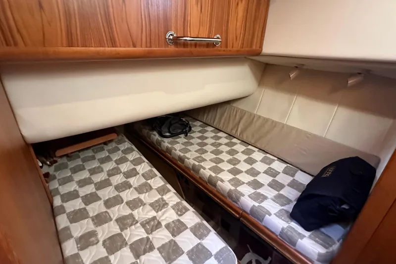 Lucky Dog Yacht Photos Pics 2002 Mainship 390 Trawler cabin with twin beds and wooden cabinetry.