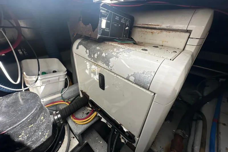 Lucky Dog Yacht Photos Pics Engine room of 2002 Mainship 390 Trawler with worn equipment and wiring.