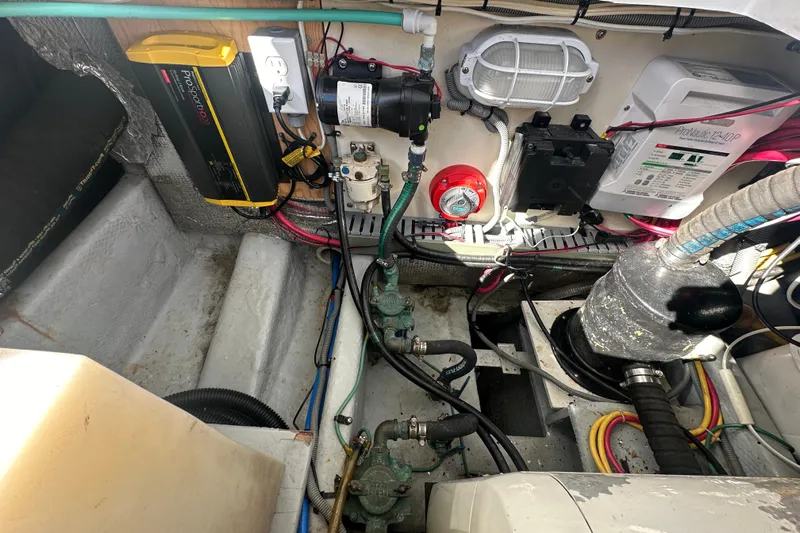 Lucky Dog Yacht Photos Pics Engine room of 2002 Mainship 390 Trawler with various mechanical components and wiring.