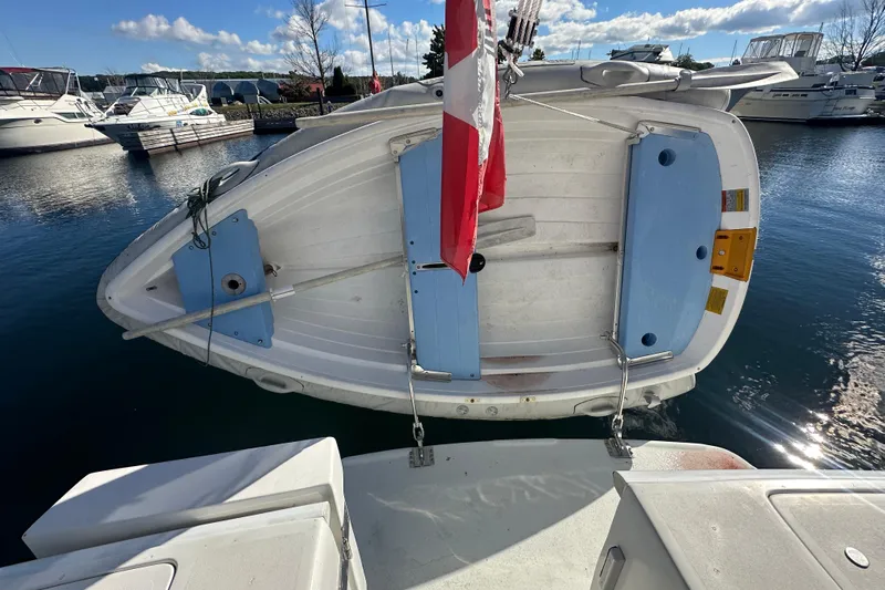 Lucky Dog Yacht Photos Pics A 2002 Mainship 390 Trawler with a dinghy attached at the stern in a marina.