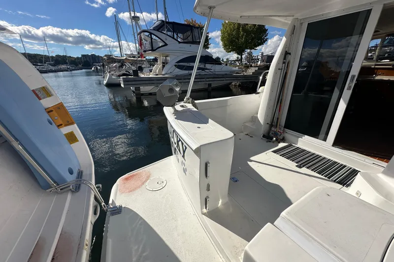 Lucky Dog Yacht Photos Pics 2002 Mainship 390 Trawler docked at marina, showcasing spacious deck and serene water view.