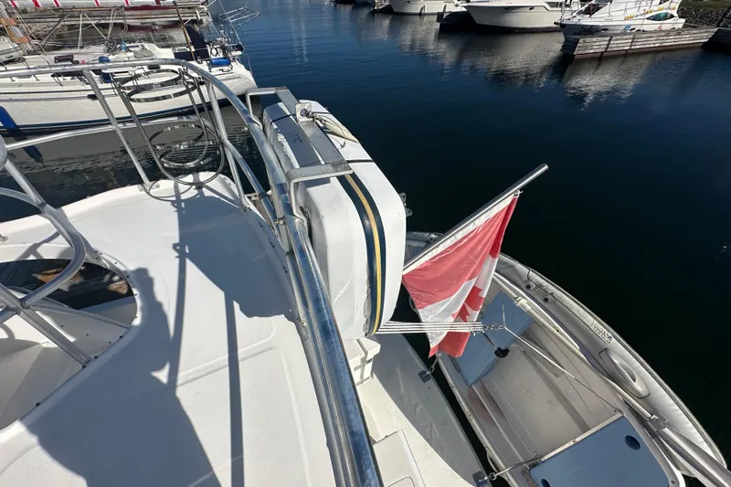 Lucky Dog Yacht Photos Pics 2002 Mainship 390 Trawler with Canadian flag, docked in a marina.