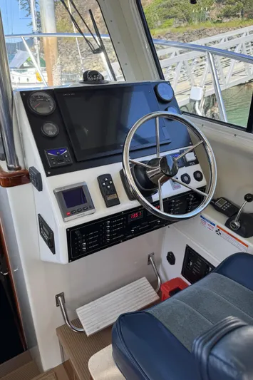  Yacht Photos Pics 2010 Ocean Sport Roamer boat dashboard with steering wheel and navigation controls.