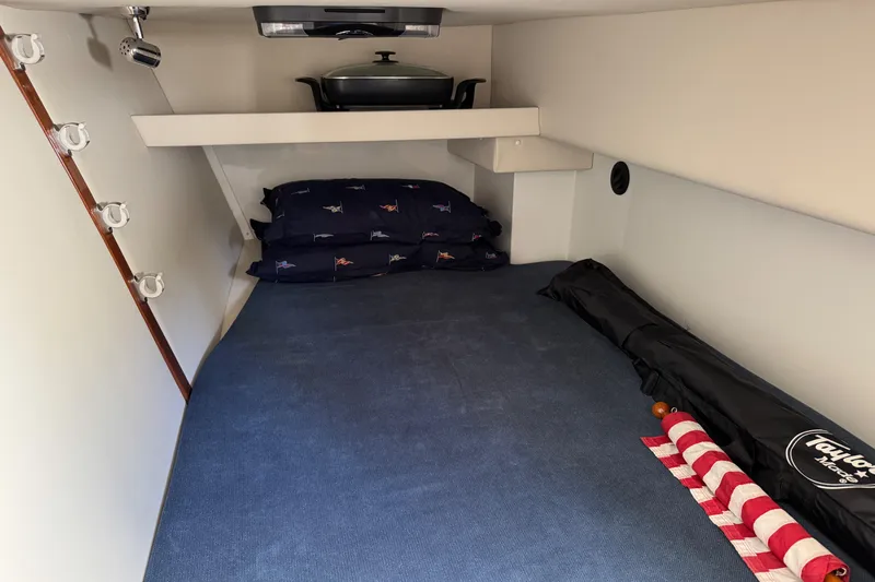  Yacht Photos Pics 2010 Ocean Sport Roamer cabin interior with bed, pillows, and storage space.