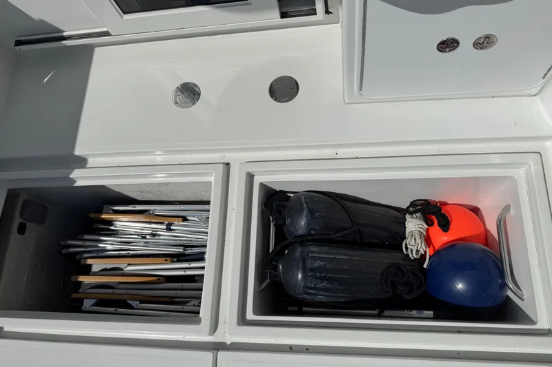  Yacht Photos Pics Storage compartments on a 2010 Ocean Sport Roamer boat, containing equipment and gear.