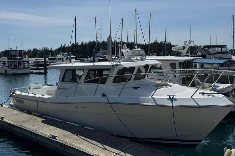  Yacht Photos Pics 2010 Ocean Sport Roamer boat docked at marina, surrounded by other vessels.