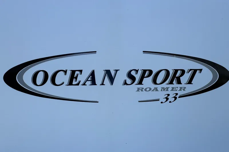  Yacht Photos Pics Ocean Sport Roamer 33 logo, 2010 model, sleek design on a light background.