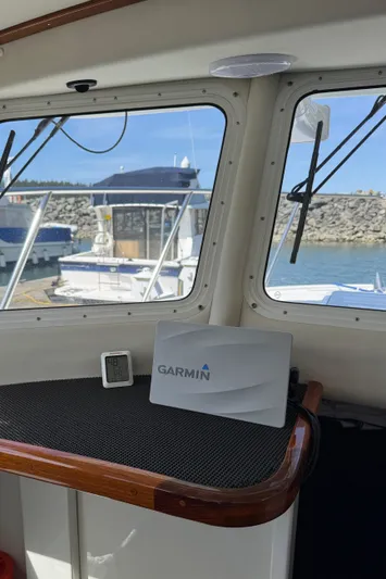  Yacht Photos Pics 2010 Ocean Sport Roamer interior with Garmin navigation system, docked at marina.