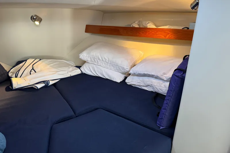  Yacht Photos Pics Cozy cabin interior of 2010 Ocean Sport Roamer with blue bedding and pillows.