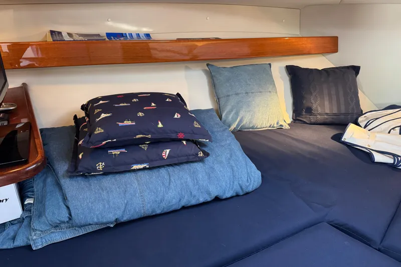  Yacht Photos Pics Cozy cabin interior of 2010 Ocean Sport Roamer with pillows and wooden shelf.