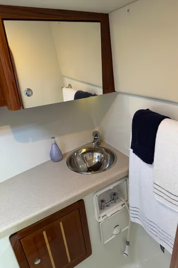  Yacht Photos Pics 2010 Ocean Sport Roamer bathroom with sink, mirror, and towel rack.