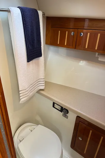  Yacht Photos Pics 2010 Ocean Sport Roamer bathroom with wooden cabinets and towel rack.