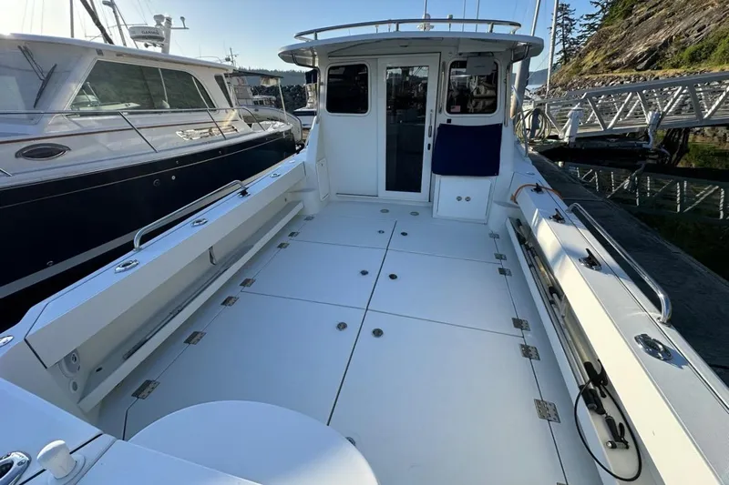  Yacht Photos Pics 2010 Ocean Sport Roamer boat with spacious deck, docked at marina.