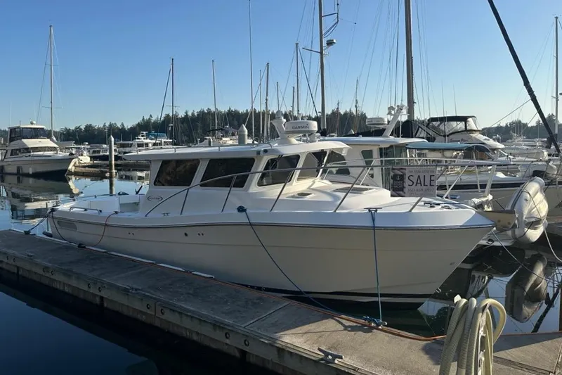  Yacht Photos Pics 2010 Ocean Sport Roamer boat docked at marina, surrounded by other vessels.