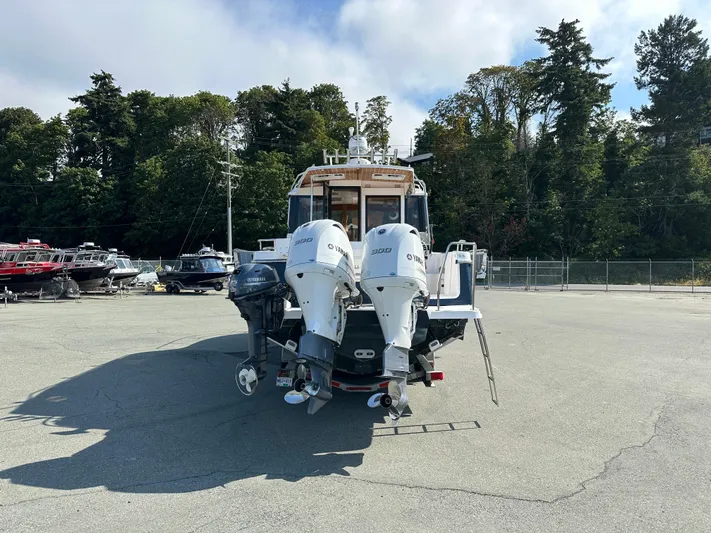  Yacht Photos Pics 2018 Cutwater C-302 Coupe with dual Yamaha outboard engines in a marina setting.