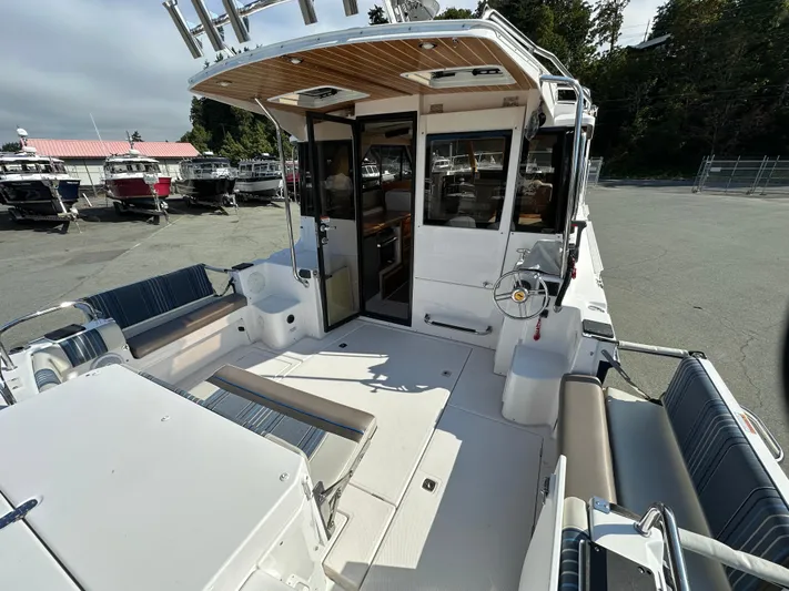  Yacht Photos Pics 2018 Cutwater C-302 Coupe boat interior with seating and helm, docked outdoors.