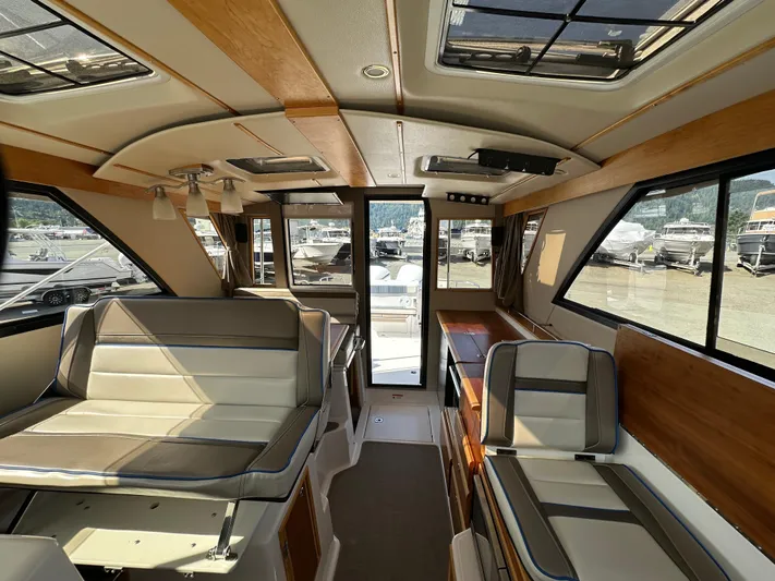  Yacht Photos Pics Interior of 2018 Cutwater C-302 Coupe boat with seating and windows.