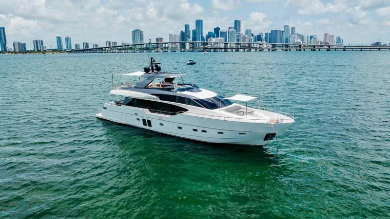 Sasa Yacht Photos Pics Luxurious 2022 Sanlorenzo SL86 yacht cruising near a city skyline on a sunny day.