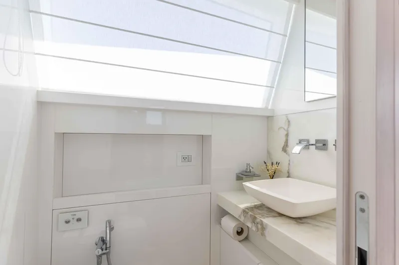 Sasa Yacht Photos Pics Luxurious bathroom in 2022 Sanlorenzo SL86 yacht with modern fixtures and natural light.