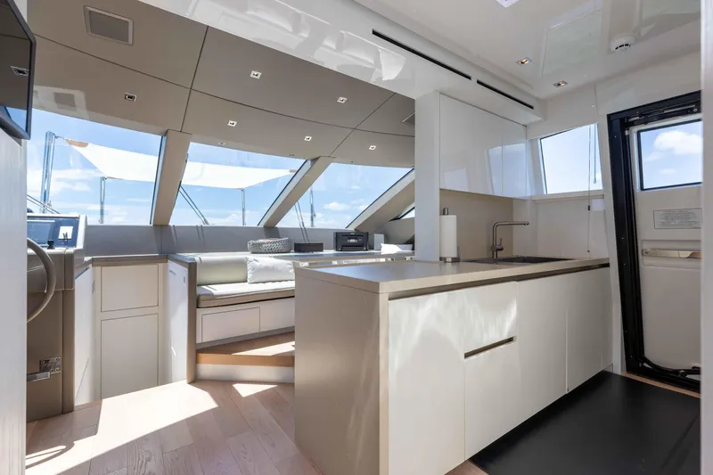 Sasa Yacht Photos Pics Luxurious interior of 2022 Sanlorenzo SL86 yacht with modern kitchen and seating area.