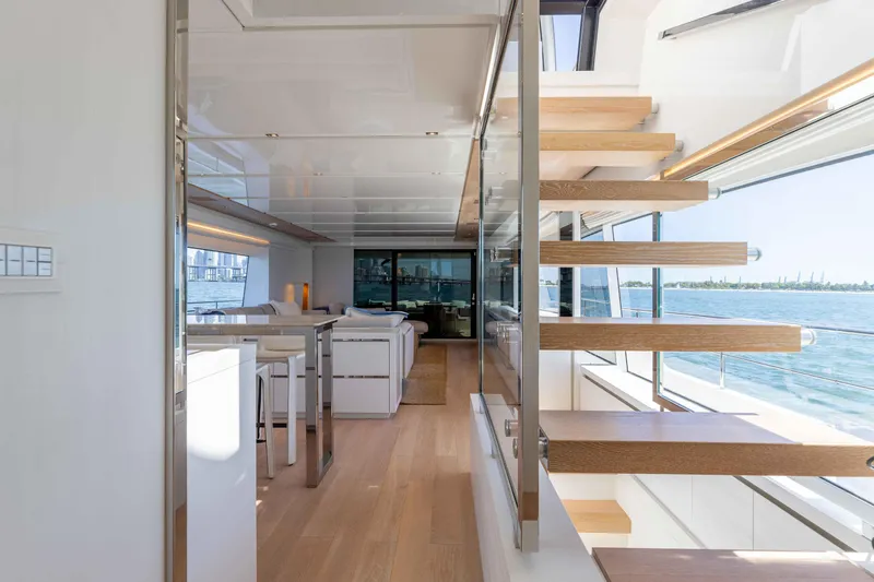 Sasa Yacht Photos Pics Luxurious interior of 2022 Sanlorenzo SL86 yacht with modern staircase and ocean view.