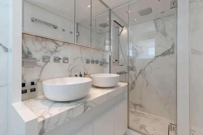 Sasa Yacht Photos Pics Luxurious marble bathroom with dual sinks and glass shower in 2022 Sanlorenzo SL86 yacht.