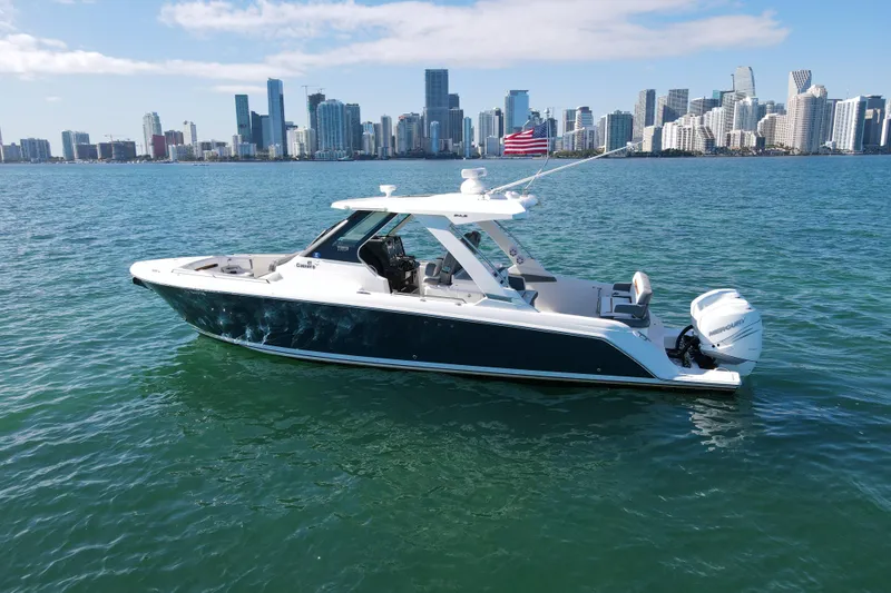  Yacht Photos Pics 2022 Tiara Yachts 34 LS boat on water with city skyline background.
