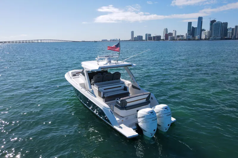  Yacht Photos Pics 2022 Tiara Yachts 34 LS on water with city skyline in background.