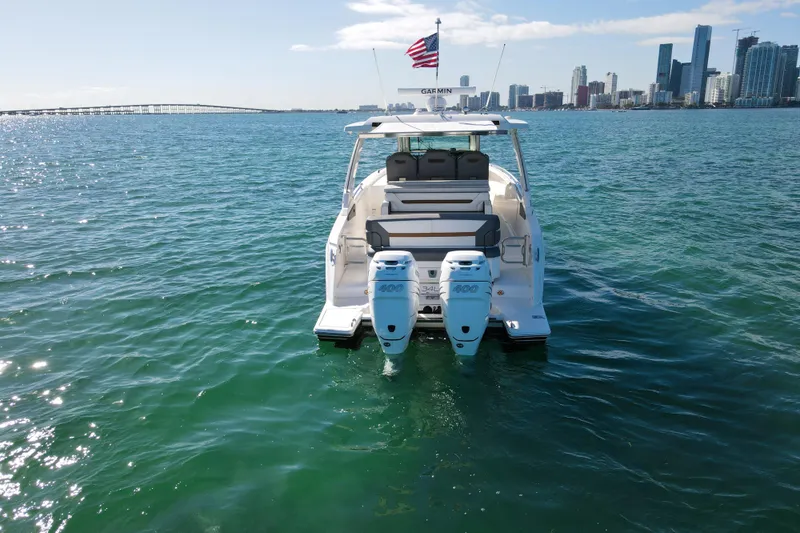  Yacht Photos Pics 2022 Tiara Yachts 34 LS on water with city skyline in background.