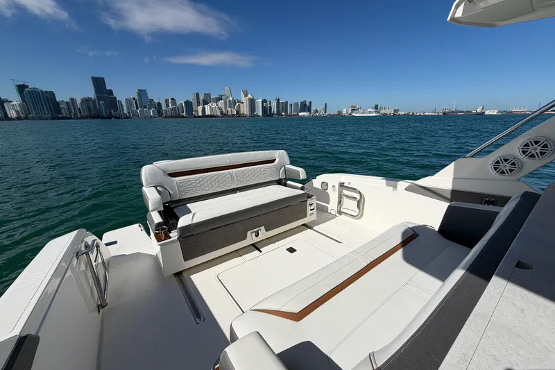  Yacht Photos Pics 2022 Tiara Yachts 34 LS on water with city skyline in background.