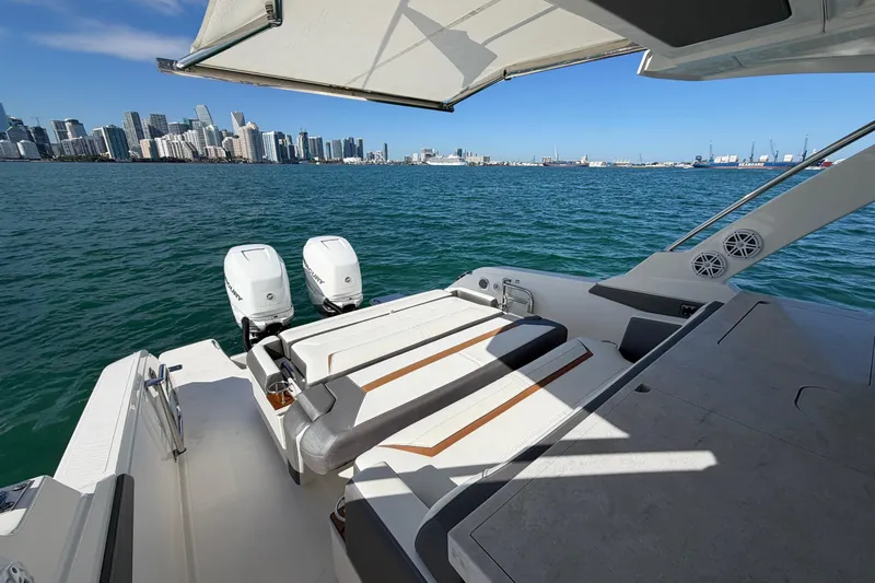  Yacht Photos Pics 2022 Tiara Yachts 34 LS on water with city skyline in background.