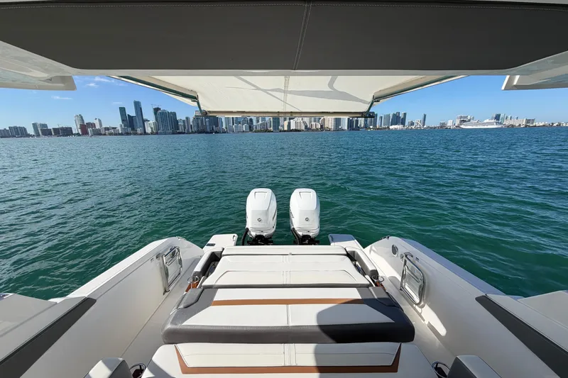  Yacht Photos Pics 2022 Tiara Yachts 34 LS on water with city skyline view.
