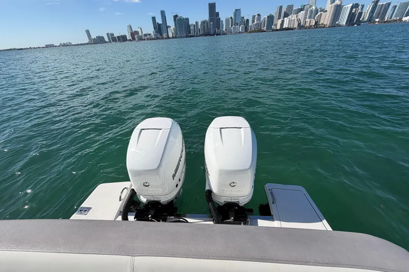  Yacht Photos Pics 2022 Tiara Yachts 34 LS with dual engines, city skyline in background.