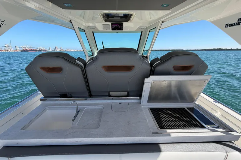  Yacht Photos Pics 2022 Tiara Yachts 34 LS interior with seating, sink, and grill, overlooking the ocean.