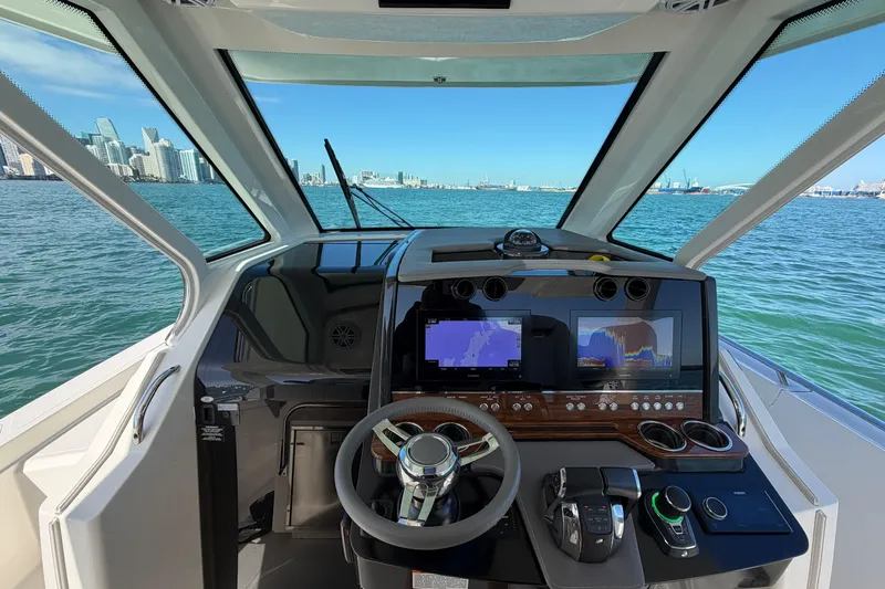  Yacht Photos Pics Interior view of 2022 Tiara Yachts 34 LS helm with navigation screens and steering wheel.