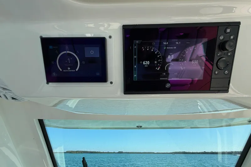  Yacht Photos Pics Dashboard of 2022 Tiara Yachts 34 LS with digital displays and sea view.