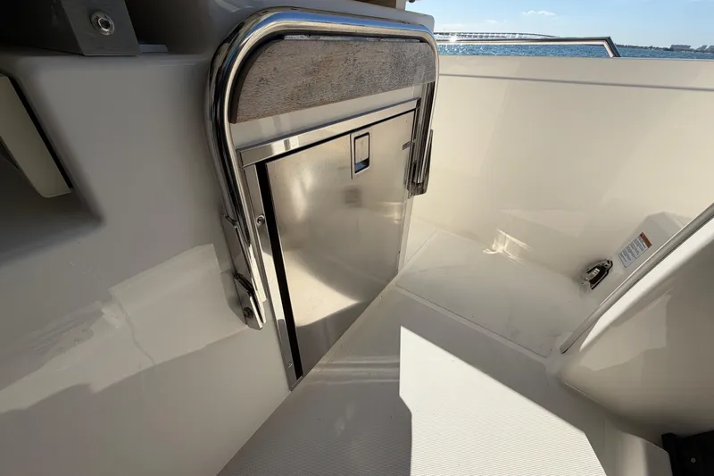  Yacht Photos Pics 2022 Tiara Yachts 34 LS interior detail with stainless steel storage compartment.