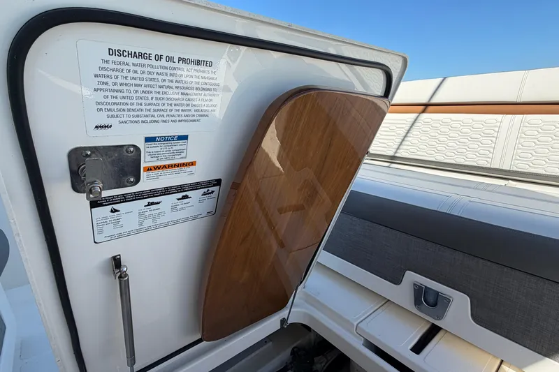  Yacht Photos Pics 2022 Tiara Yachts 34 LS interior with open hatch and safety warnings.