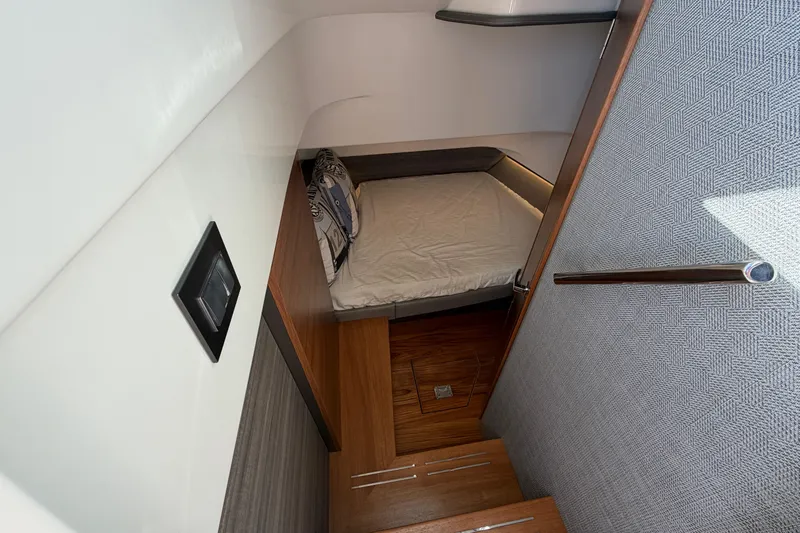 Yacht Photos Pics 2022 Tiara Yachts 34 LS cabin interior with bed and wooden flooring.