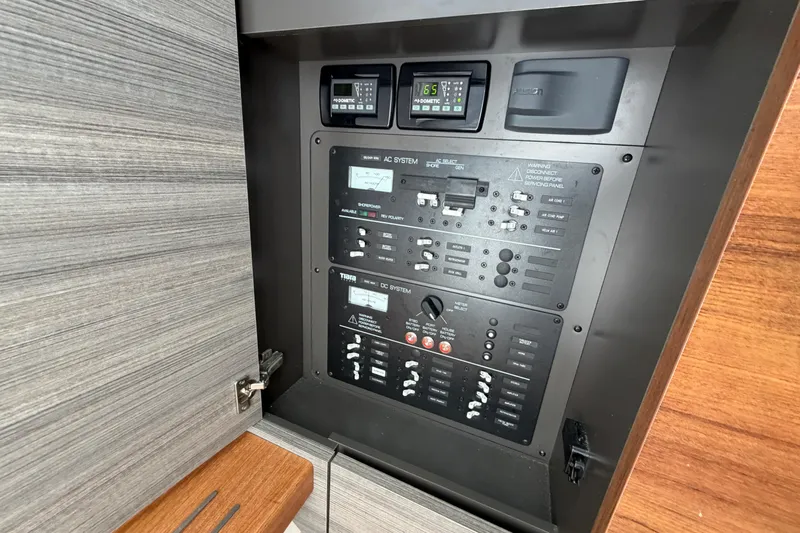  Yacht Photos Pics Electrical control panel on a 2022 Tiara Yachts 34 LS, featuring AC and DC systems.