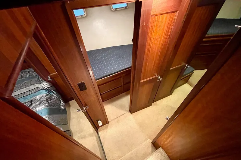 Freedom Yacht Photos Pics Interior of 1976 Hatteras 48 Long Range Cruiser with wood paneling and cozy sleeping quarters.